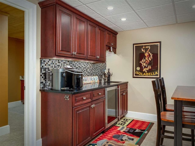 6598 Forest Way, Harbor Springs, MI 49740 - kitchen featuring beverage cooler, reddish brown cabinets, decorative backsplash, recessed lighting, and dark countertops