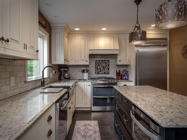 6598 Forest Way, Harbor Springs, MI 49740 - kitchen with stainless steel appliances, custom exhaust hood, light stone countertops, decorative backsplash, and recessed lighting