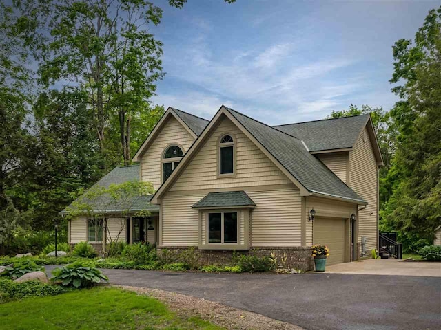 6598 Forest Way, Harbor Springs, MI 49740 - view of front of house featuring asphalt driveway, a garage, and a shingled roof