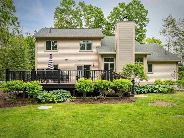 6598 Forest Way, Harbor Springs, MI 49740 - back of property with a chimney, a yard, a wooden deck, and a shingled roof