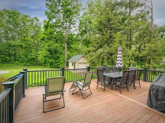 6598 Forest Way, Harbor Springs, MI 49740 - deck with outdoor dining space, area for grilling, a lawn, and a shed