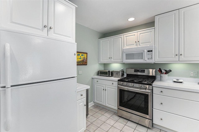 1835 Bluffs Edge, Harbor Springs, MI 49740 - kitchen featuring white appliances, light countertops, light tile patterned floors, white cabinetry, and recessed lighting