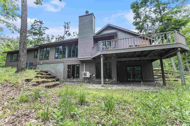 1835 Bluffs Edge, Harbor Springs, MI 49740 - rear view of house with a chimney, a wooden deck, and french doors