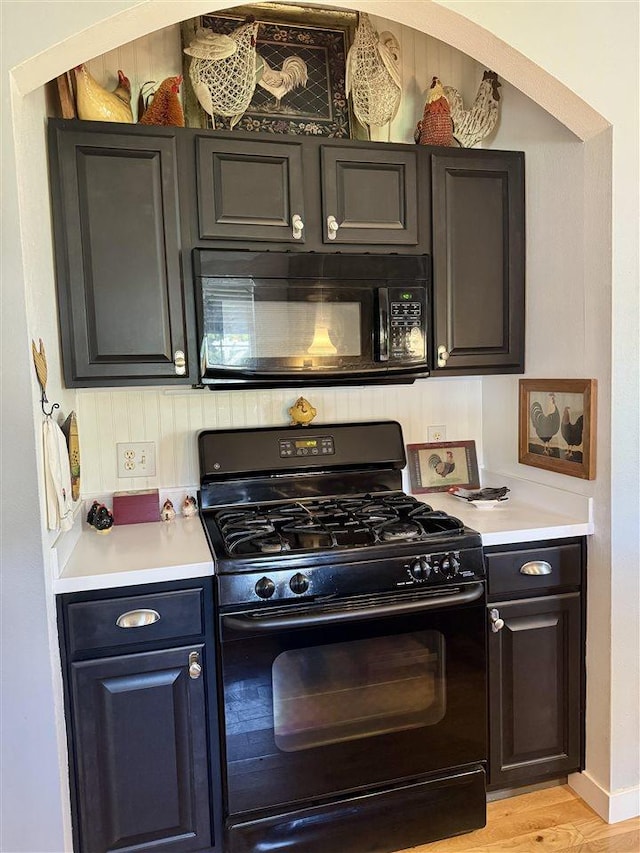 7570 Bay Meadow Dr, Harbor Springs, MI 49740 - kitchen featuring black appliances, light countertops, and light wood finished floors