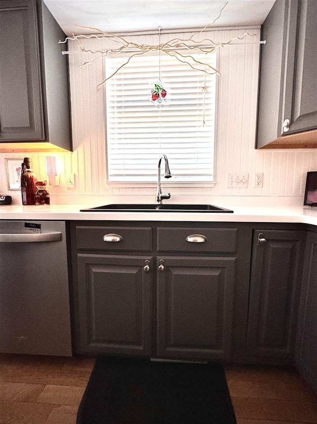 7570 Bay Meadow Dr, Harbor Springs, MI 49740 - kitchen with stainless steel dishwasher, light countertops, gray cabinets, and healthy amount of natural light