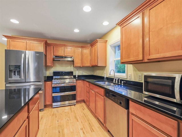 1885 Lalonde Rd, East Jordan, MI 49727 - kitchen with appliances with stainless steel finishes, under cabinet range hood, recessed lighting, light wood-style flooring, and dark stone countertops