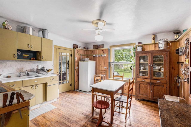 5980 Stanek Rd, East Jordan, MI 49727 - kitchen with freestanding refrigerator, ceiling fan, light wood-style floors, tasteful backsplash, and light countertops