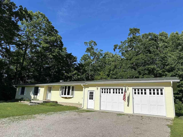 4505 S State Rd, Harbor Springs, MI 49740 - view of front of property featuring a garage and a front lawn