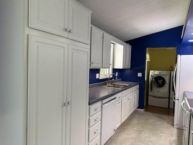 4505 S State Rd, Harbor Springs, MI 49740 - kitchen featuring white appliances, washer / dryer, dark countertops, white cabinets, and a textured ceiling