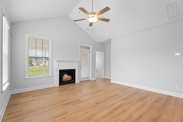 3320 Navin Trl, Roebuck, SC 29376 - unfurnished living room featuring a ceiling fan, a lit fireplace, light wood-type flooring, and high vaulted ceiling
