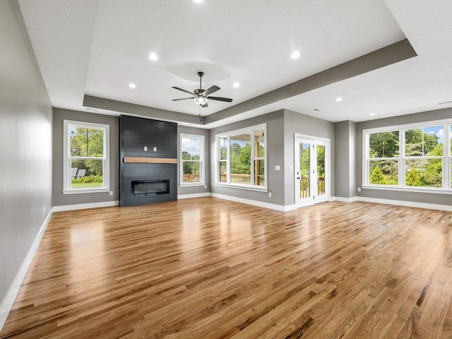 708 Mello Dr, Lyman, SC 29365 - unfurnished living room with wood finished floors, a fireplace, a raised ceiling, and recessed lighting