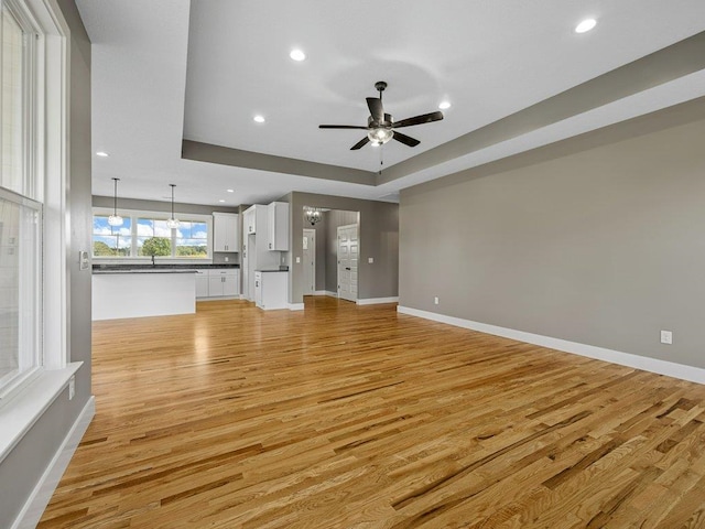 708 Mello Dr, Lyman, SC 29365 - unfurnished living room featuring light wood-style floors, a ceiling fan, recessed lighting, and a raised ceiling