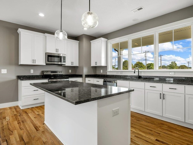 708 Mello Dr, Lyman, SC 29365 - kitchen featuring appliances with stainless steel finishes, light wood-style flooring, white cabinetry, and recessed lighting