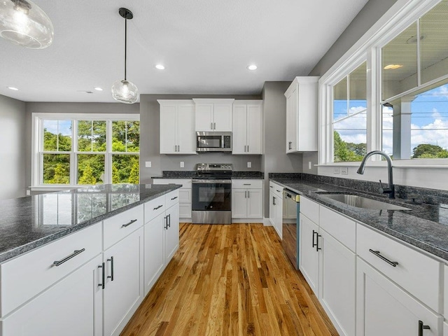 708 Mello Dr, Lyman, SC 29365 - kitchen with appliances with stainless steel finishes, light wood-type flooring, plenty of natural light, white cabinets, and recessed lighting