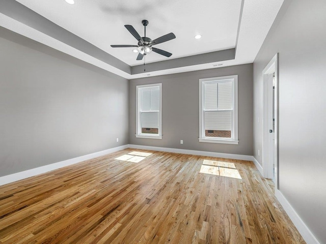 708 Mello Dr, Lyman, SC 29365 - empty room with a raised ceiling, light wood-type flooring, a ceiling fan, and recessed lighting