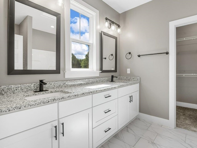 708 Mello Dr, Lyman, SC 29365 - bathroom with double vanity, marble look tile flooring, and a walk in closet