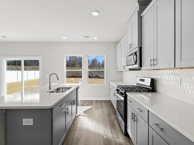 119 Martel Dr, Spartanburg, SC 29301 - kitchen featuring appliances with stainless steel finishes, a center island with sink, dark wood-style floors, healthy amount of natural light, and recessed lighting