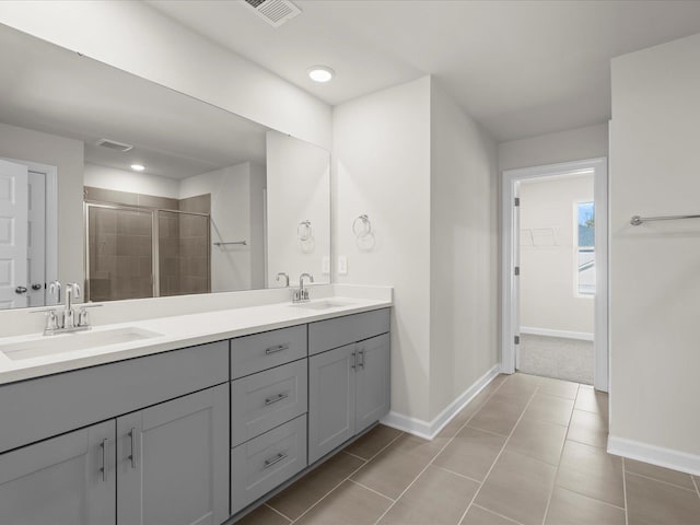 119 Martel Dr, Spartanburg, SC 29301 - bathroom with double vanity, a shower stall, a walk in closet, tile patterned flooring, and recessed lighting