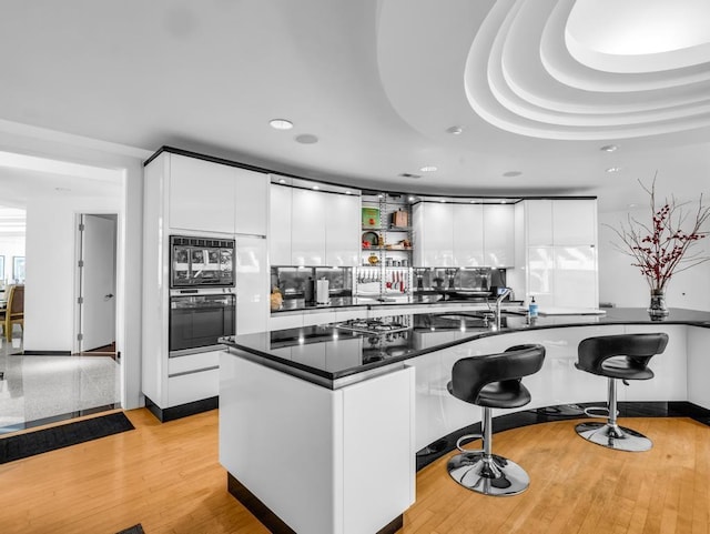 110 W King Ridge St, Gaffney, SC 29341 - kitchen with black appliances, modern cabinets, recessed lighting, a kitchen bar, and white cabinets
