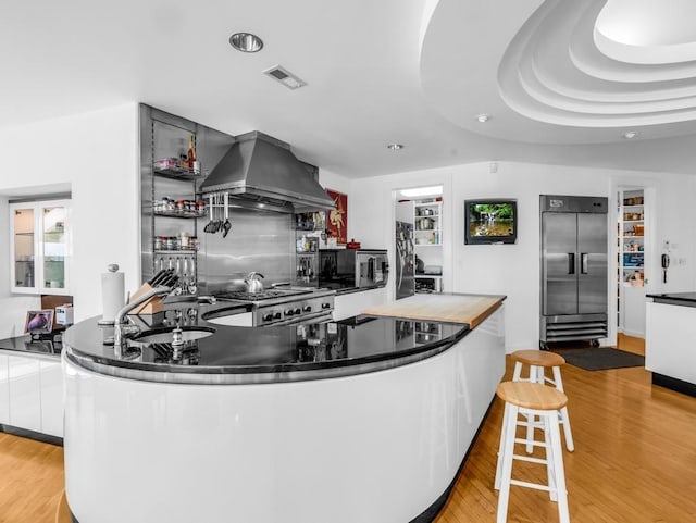 110 W King Ridge St, Gaffney, SC 29341 - kitchen featuring stainless steel built in refrigerator, island exhaust hood, white cabinets, light wood-style floors, and recessed lighting