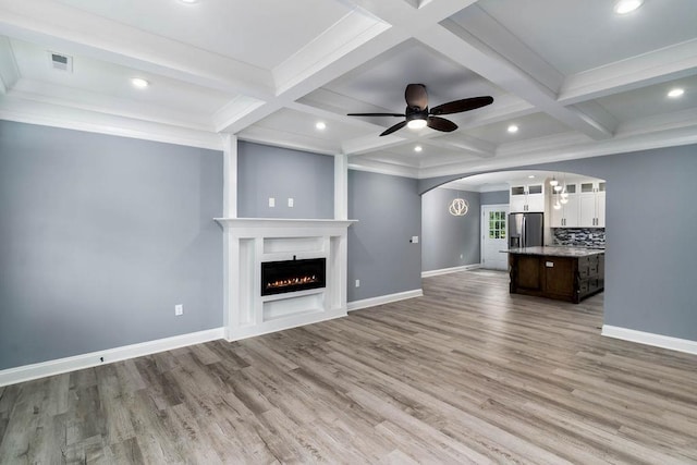331 Skyline Rd, Greer, SC 29651 - unfurnished living room featuring arched walkways, coffered ceiling, light wood-type flooring, ceiling fan, and beamed ceiling