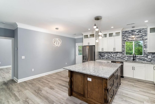 331 Skyline Rd, Greer, SC 29651 - kitchen with stainless steel appliances, tasteful backsplash, white cabinetry, hanging light fixtures, and ornamental molding