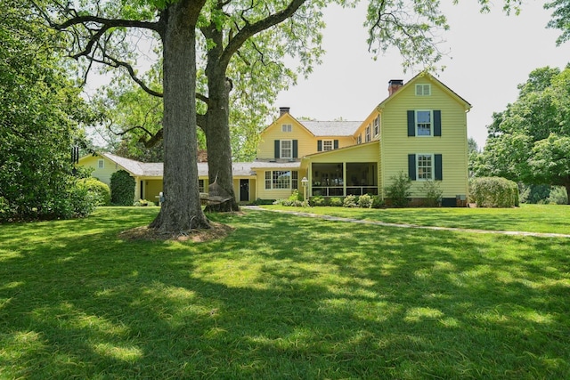 835 Jackson Grove Rd, Columbus, NC 28722 - rear view of property with a sunroom, a chimney, and a lawn