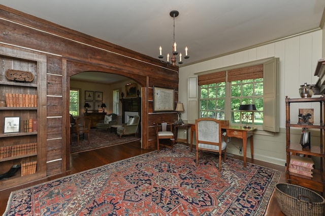 835 Jackson Grove Rd, Columbus, NC 28722 - living area with arched walkways, wood finished floors, a chandelier, a decorative wall, and wooden walls