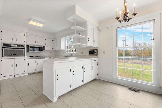 802 Hickory Hollow Rd, Inman, SC 29349 - kitchen with appliances with stainless steel finishes, a chandelier, open shelves, light countertops, and white cabinetry
