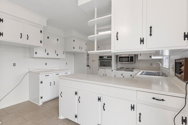 802 Hickory Hollow Rd, Inman, SC 29349 - kitchen with stainless steel appliances, a peninsula, white cabinetry, and light countertops