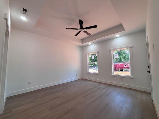 179 Cedar Ave, Wellford, SC 29385 - spare room featuring a raised ceiling, wood finished floors, a ceiling fan, and recessed lighting