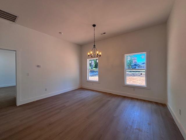 179 Cedar Ave, Wellford, SC 29385 - unfurnished room with wood finished floors and a chandelier