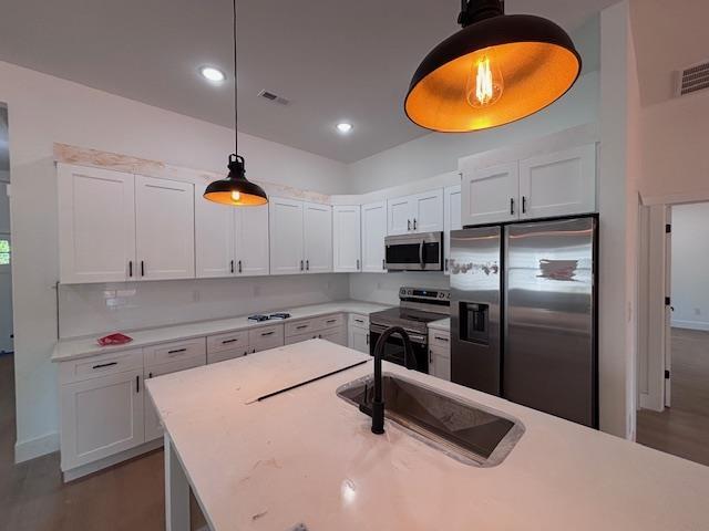 179 Cedar Ave, Wellford, SC 29385 - kitchen featuring appliances with stainless steel finishes, light countertops, white cabinetry, and recessed lighting