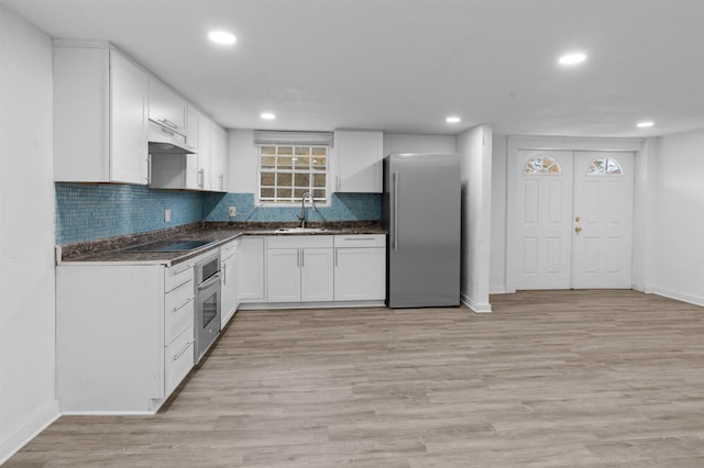 21 U St, Honea Path, SC 29654 - kitchen with stainless steel appliances, under cabinet range hood, recessed lighting, white cabinets, and light wood finished floors