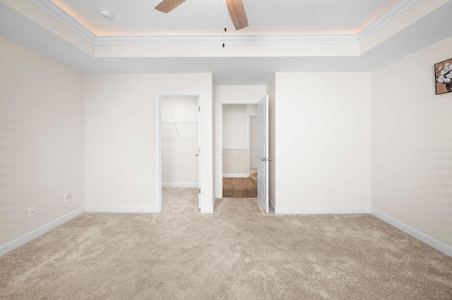 1135 Wanley Way, Boiling Springs, SC 29316 - unfurnished bedroom featuring a tray ceiling, ornamental molding, carpet, and a spacious closet