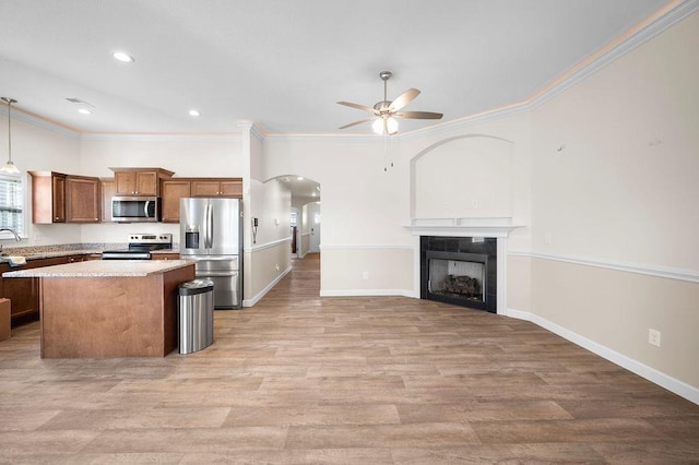1135 Wanley Way, Boiling Springs, SC 29316 - kitchen featuring appliances with stainless steel finishes, a ceiling fan, arched walkways, a center island, and light countertops