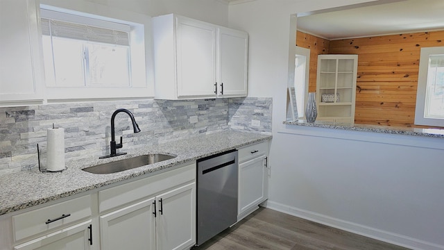 150 Cromer St, Roebuck, SC 29376 - kitchen featuring dishwasher, decorative backsplash, light stone countertops, white cabinetry, and wooden walls
