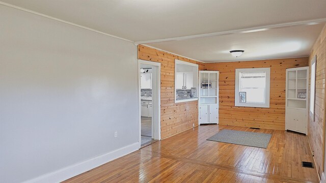 150 Cromer St, Roebuck, SC 29376 - kitchen featuring wooden walls, light wood finished floors, and ornamental molding
