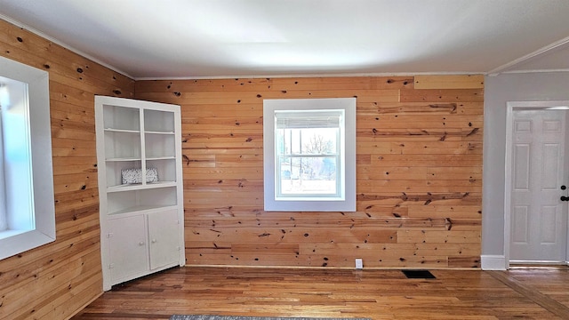 150 Cromer St, Roebuck, SC 29376 - empty room with ornamental molding, wood walls, and wood finished floors