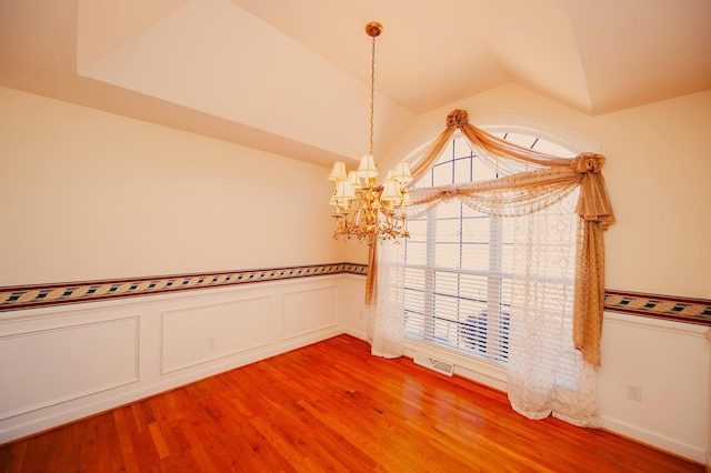 1 Carnoustie Ct, Campobello, SC 29322 - unfurnished room with a chandelier, lofted ceiling, light wood-type flooring, and wainscoting