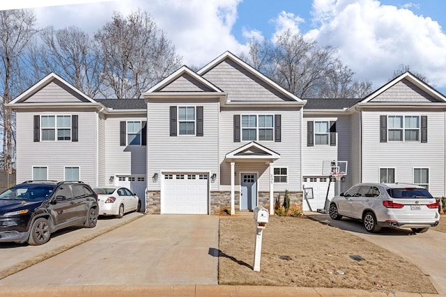 235 Marshland Ln, Greer, SC 29650 - view of property featuring concrete driveway, an attached garage, and stone siding