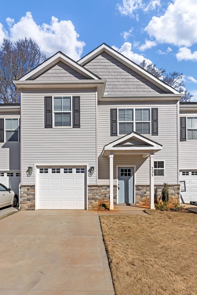 235 Marshland Ln, Greer, SC 29650 - craftsman-style house featuring stone siding, driveway, an attached garage, and a front yard