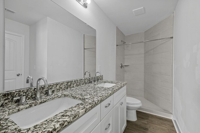 235 Marshland Ln, Greer, SC 29650 - bathroom featuring double vanity, wood finished floors, and a tile shower
