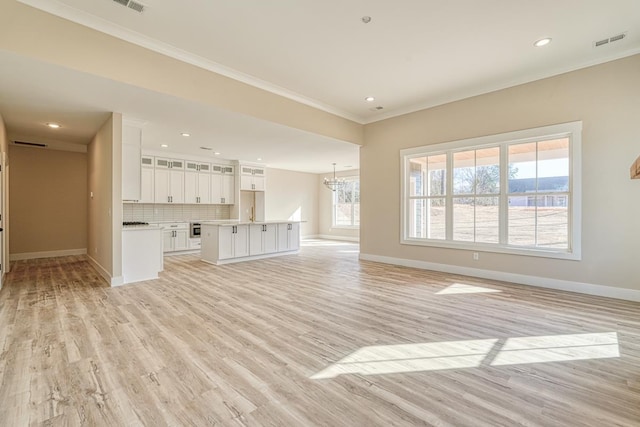155 Chestnut Dr, Woodruff, SC 29388 - unfurnished living room featuring ornamental molding, a chandelier, light wood-style flooring, and recessed lighting