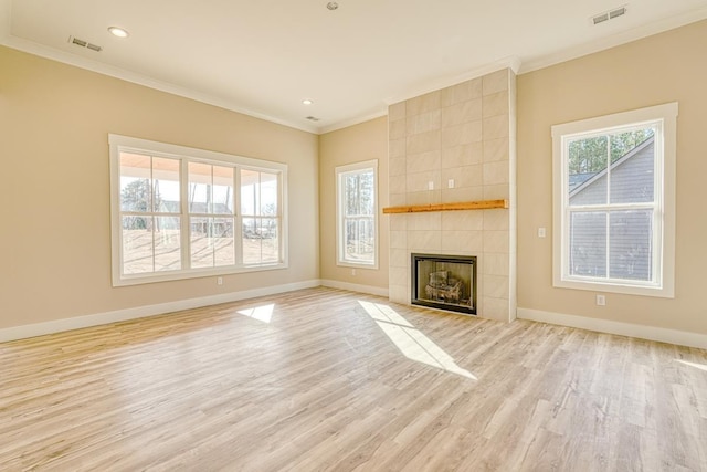 155 Chestnut Dr, Woodruff, SC 29388 - unfurnished living room with crown molding, light wood-style floors, a tiled fireplace, and recessed lighting
