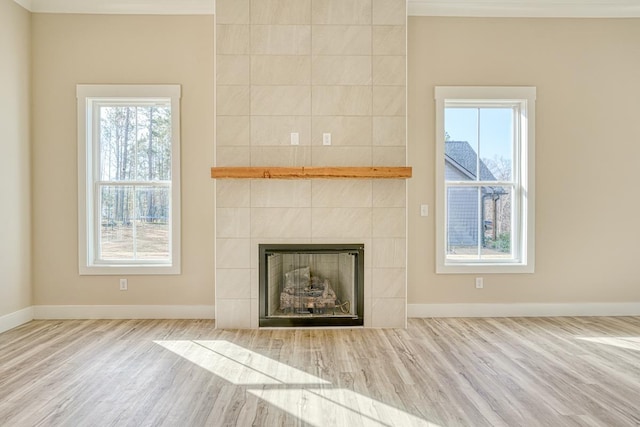 155 Chestnut Dr, Woodruff, SC 29388 - unfurnished living room featuring wood finished floors, healthy amount of natural light, and a tiled fireplace