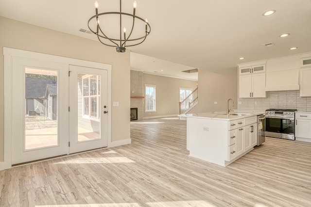 155 Chestnut Dr, Woodruff, SC 29388 - kitchen featuring stainless steel range with gas stovetop, light wood-style floors, decorative backsplash, recessed lighting, and light countertops