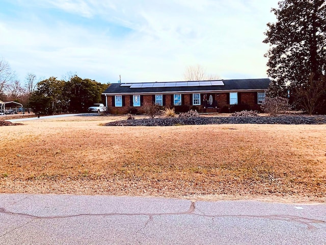 107 Mulberry St, Inman, SC 29349 - ranch-style house with roof mounted solar panels and a front lawn