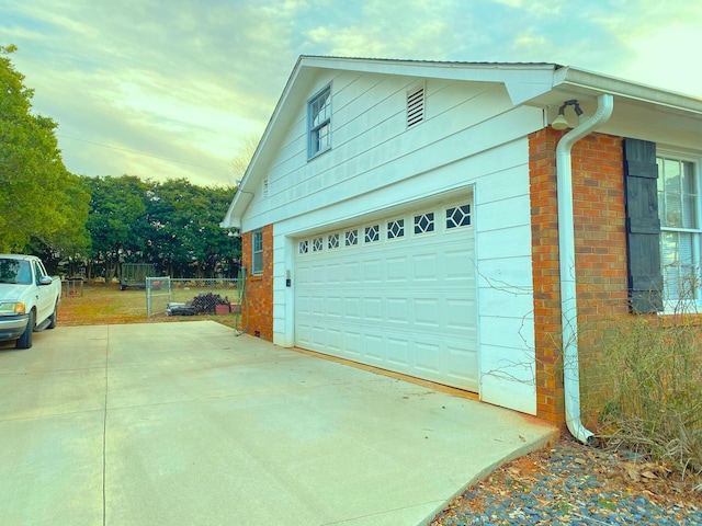 107 Mulberry St, Inman, SC 29349 - garage at dusk featuring concrete driveway