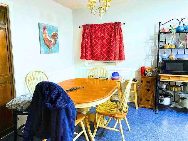 107 Mulberry St, Inman, SC 29349 - dining space with a textured ceiling, a chandelier, and a wainscoted wall